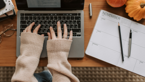 Person Typing on Laptop while Working