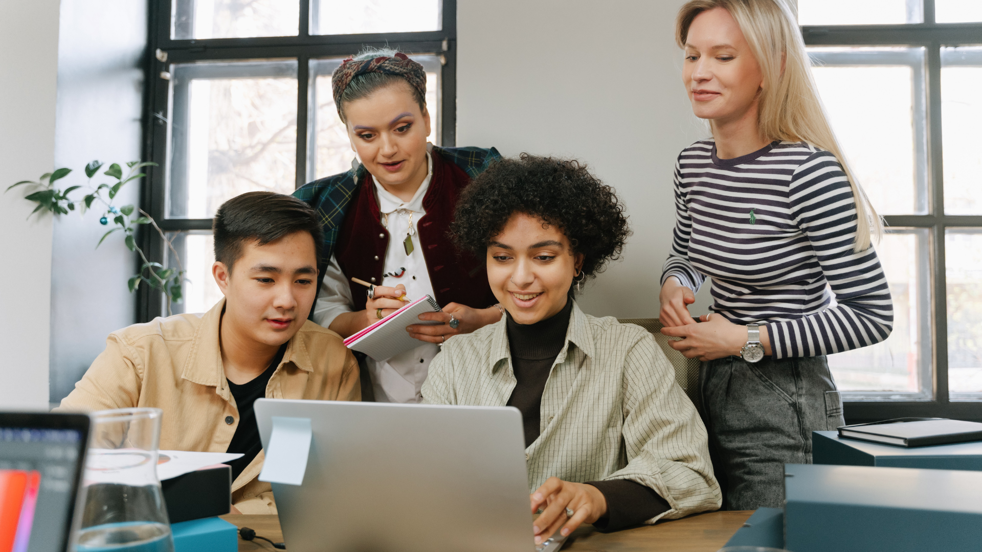 A Group of People Looking at a Laptop
