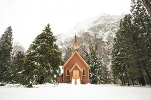 A church building with snowy landscape surrounding it